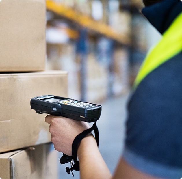 A Person Scanning Items In A Warehouse
