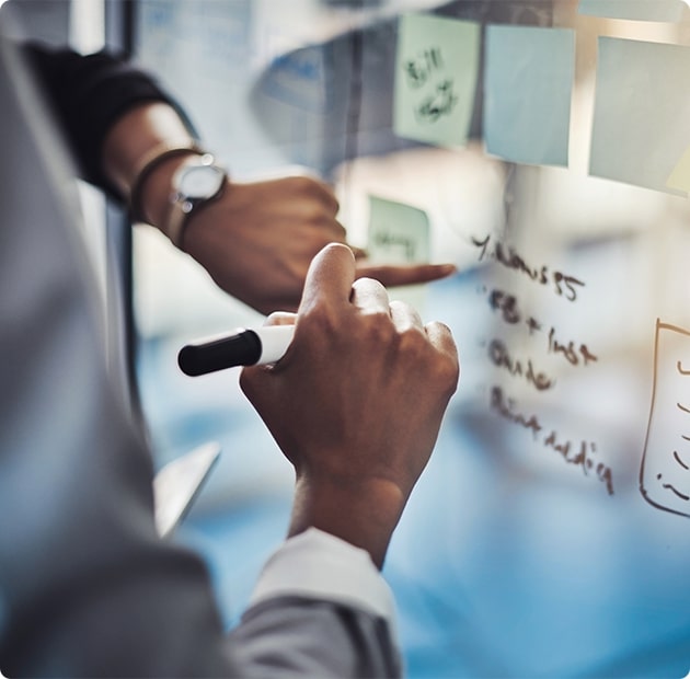 A Person Taking Notes On A Whiteboard
